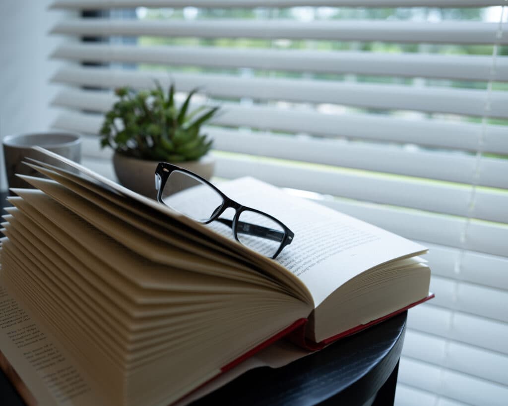 Glasses on top of a book in a library