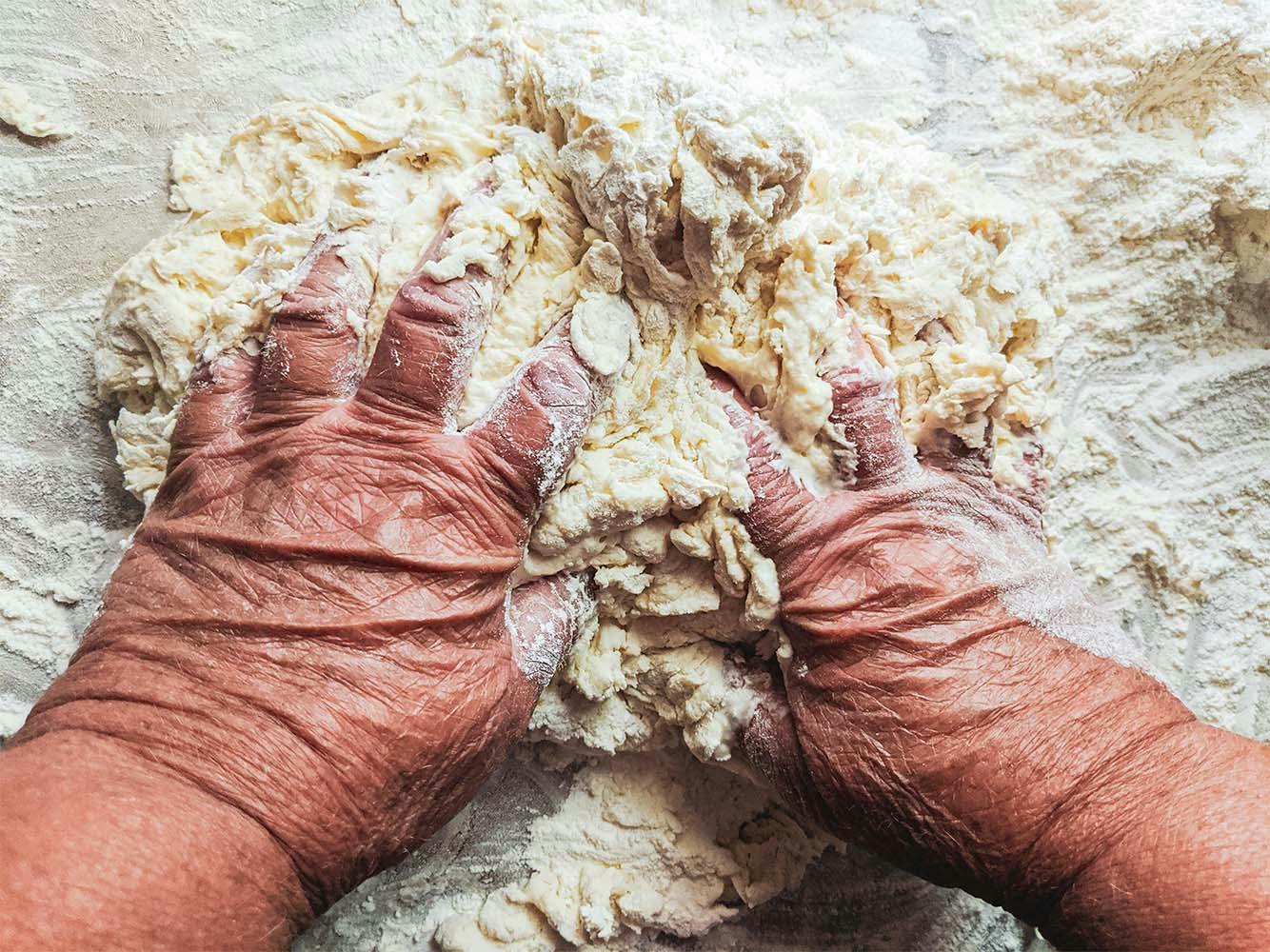 Elderly Hands Kneading Dough