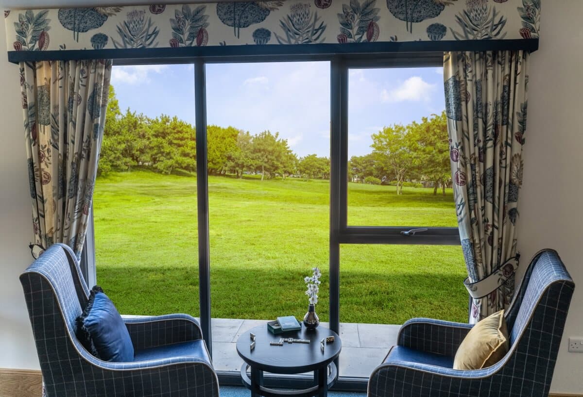 Game of Dominos by Large Window Overlooking Fields