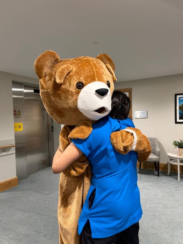 teddy-hugging-staff-member