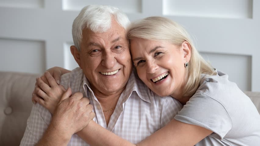 a older family member with younger family member smiling