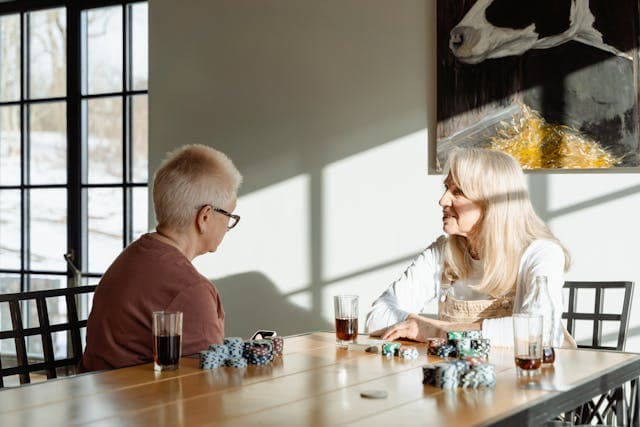 elderly people socialising in a living room in a luxury care home