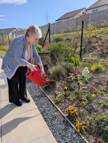 resident gardening at Woodlands care home